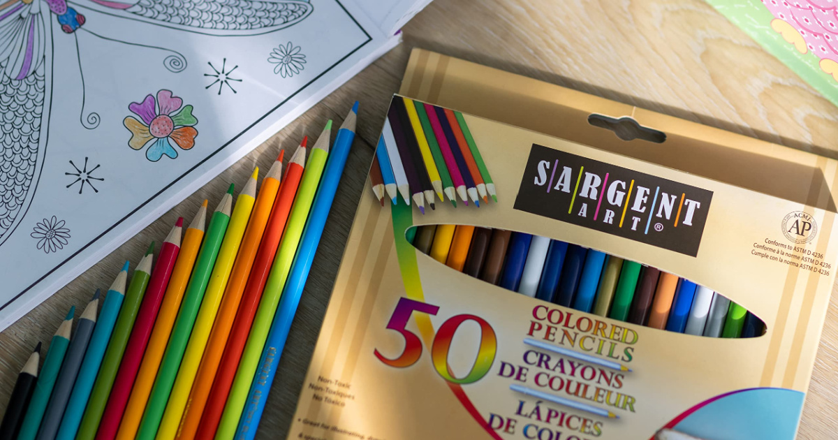 colored pencils in box and on table top near colored page