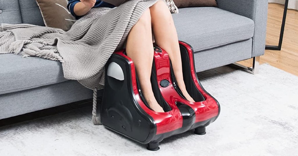 woman sitting on couch with feet in red and black foot massager