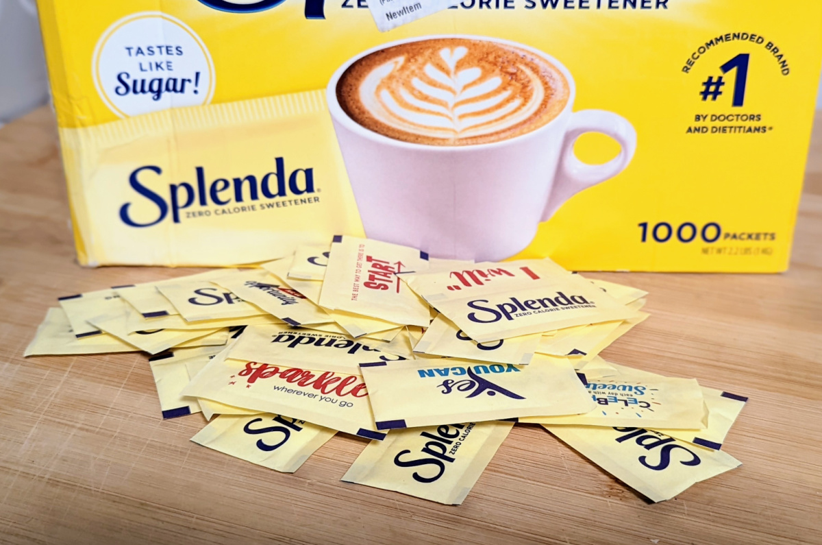 lots of Splenda packets on table top with box