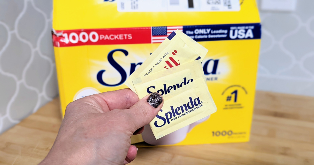 hand holding packets of Splenda sweetener