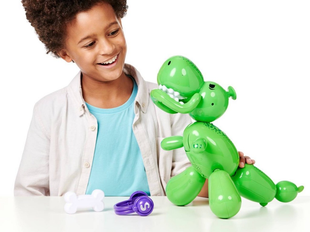 boy playing with interactive dinosaur balloon toy