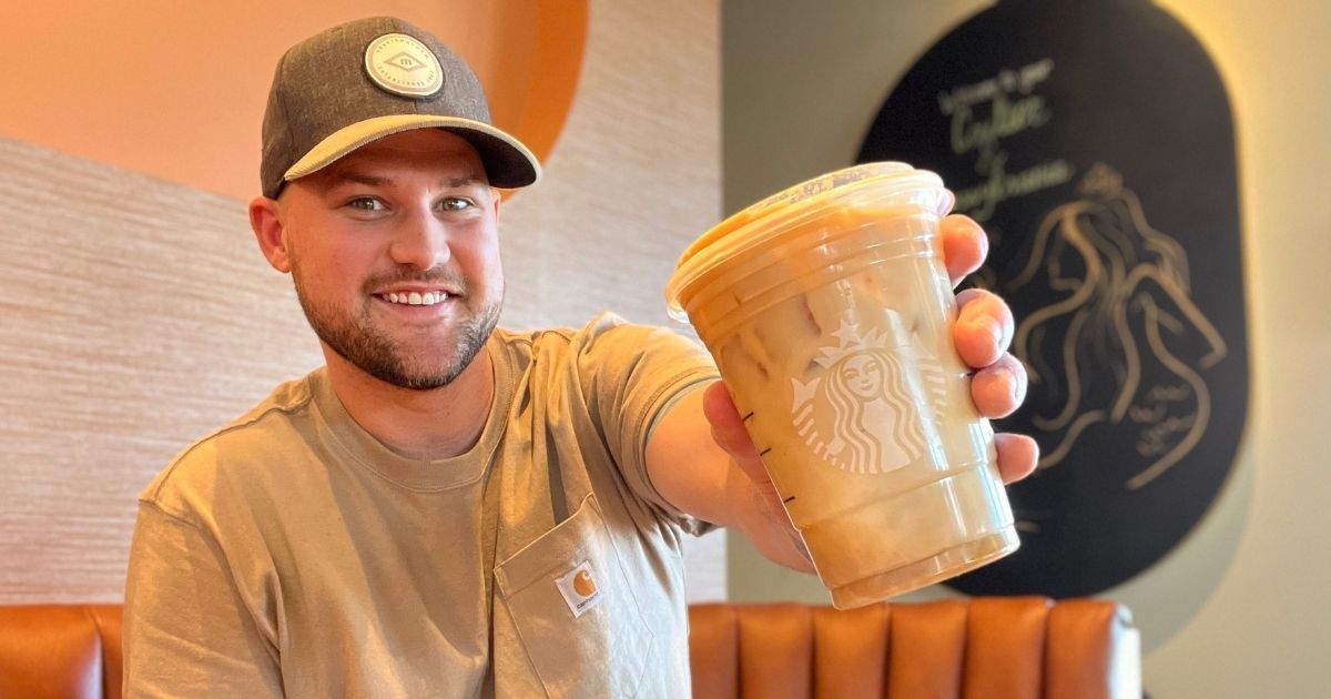 man holding a Starbucks coffee