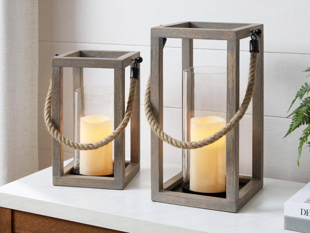 two square wood lantern candle holders on white table
