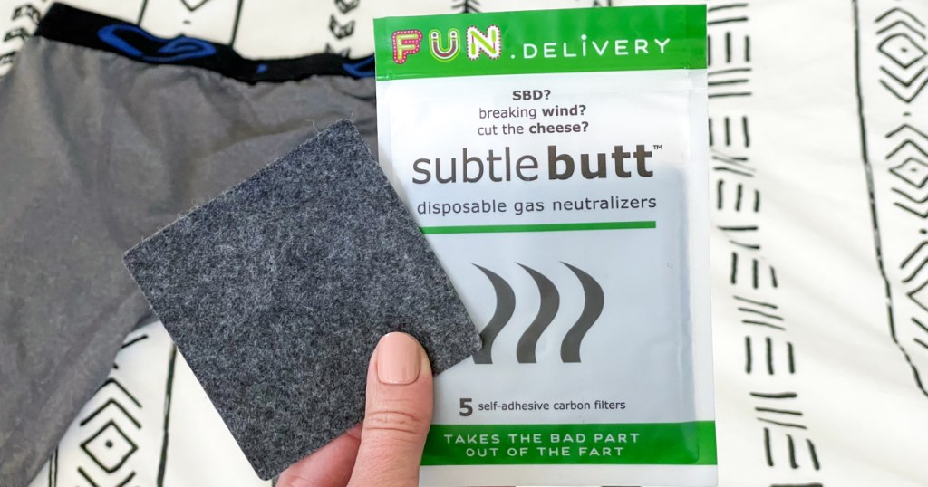 holding Subtle Butt disposable gas neutralizing pad and package 
