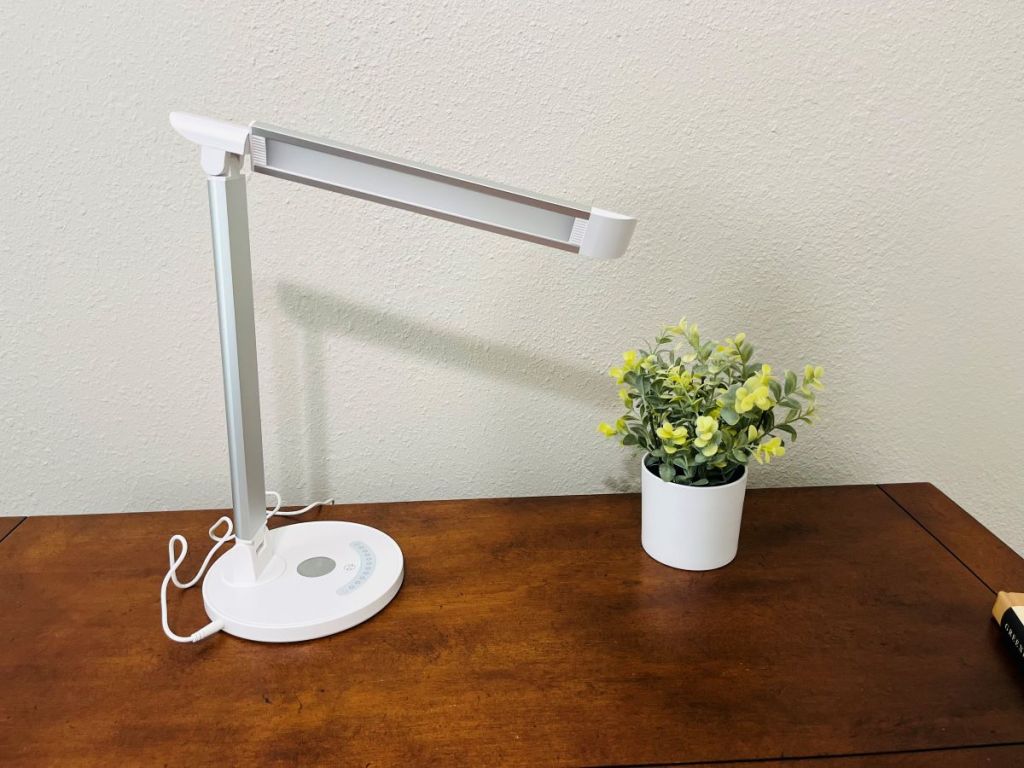 Sympa lamp on a desk by a plant