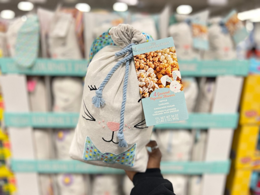 hand holding Easter Bunny sack filled with popcorn in store