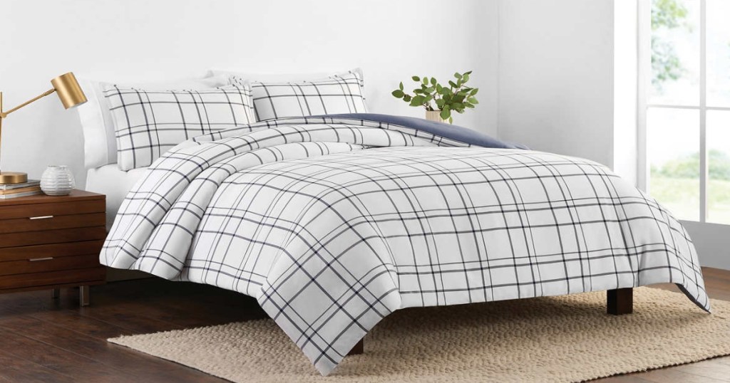 Plaid comforter set on a bed in a room