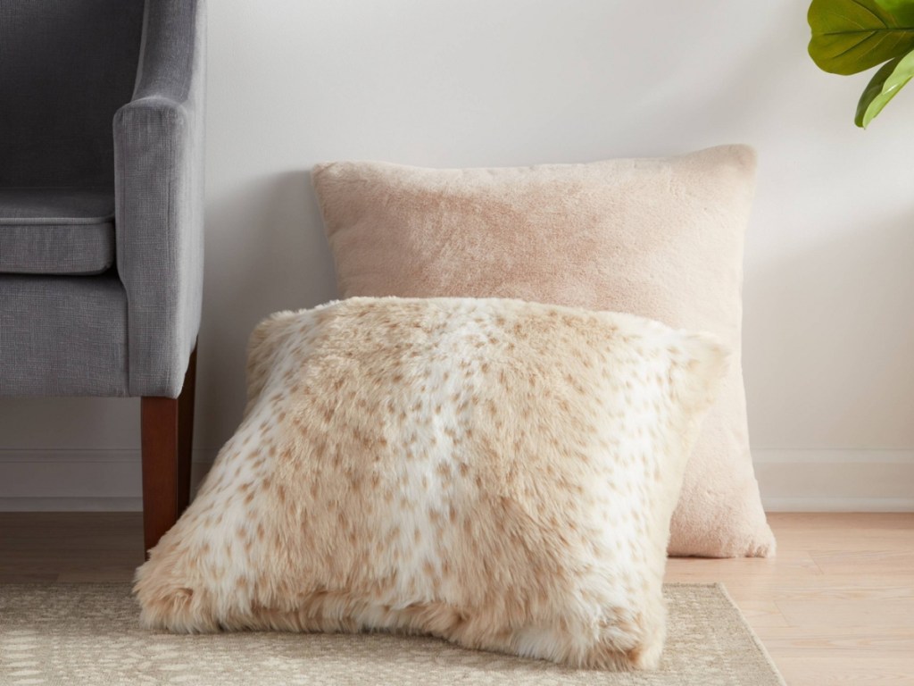 two faux fur pillows on couch