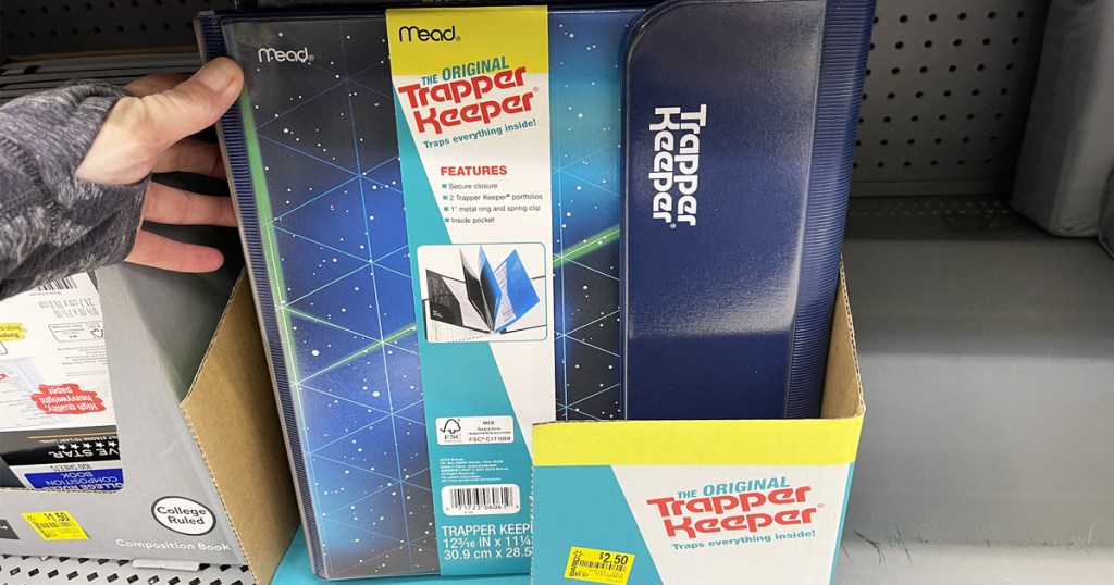 holding blue trapper keeper