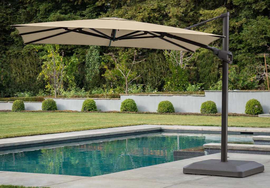tan umbrella by a pool