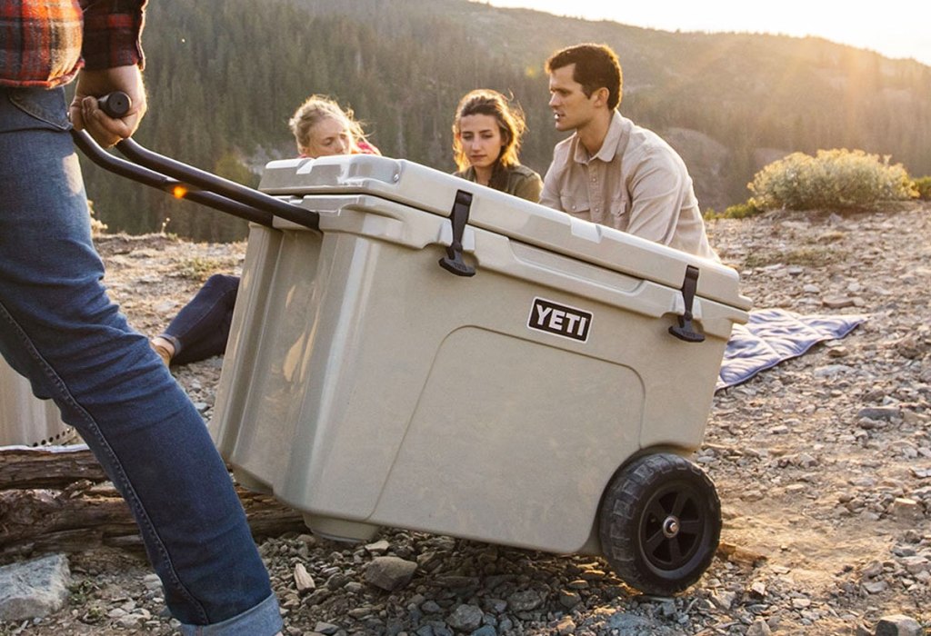 person pulling wheeled yeti cooler