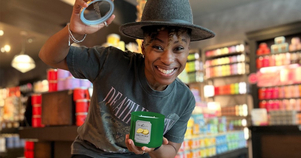 woman holding april fools pranks dill pickle candle in bath and body works store
