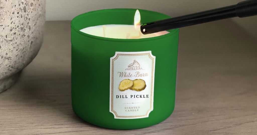 white barn bath and body works dill pickle candle being lit with lighter