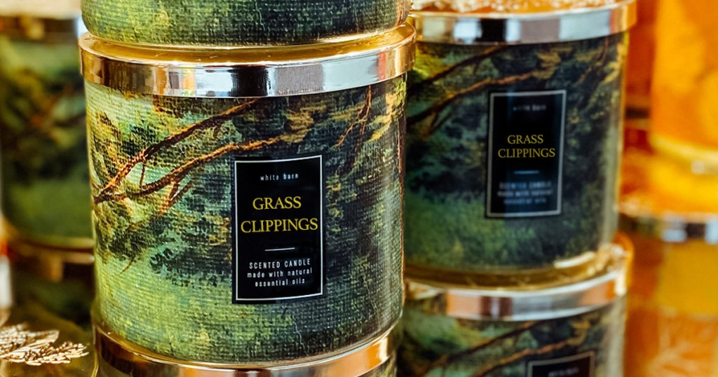 stacks of green grass clippings candles with silver lids