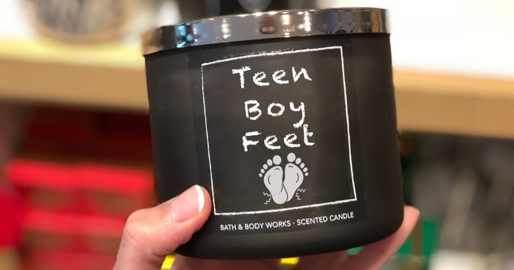 hand holding teen boy feet candle in store