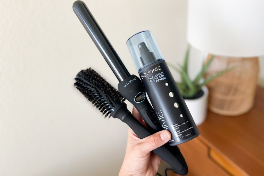 curling wand styling brush and primer in hand