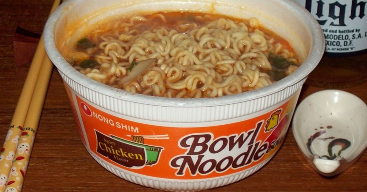 bowl noodle soup with noodles cooked inside and chopsticks laying next to it