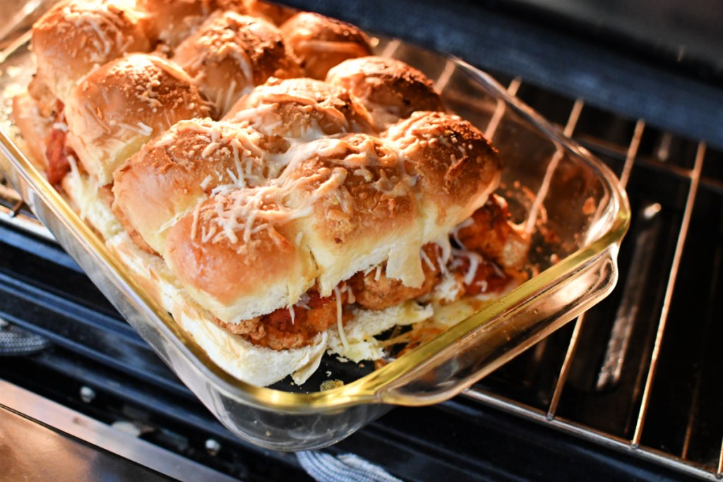 cooking parmesan chicken sliders in the oven to melt the cheese