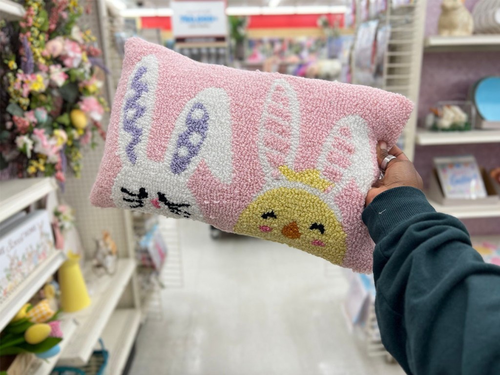 hand holding pink easter bunny pillow with white bunny and chick
