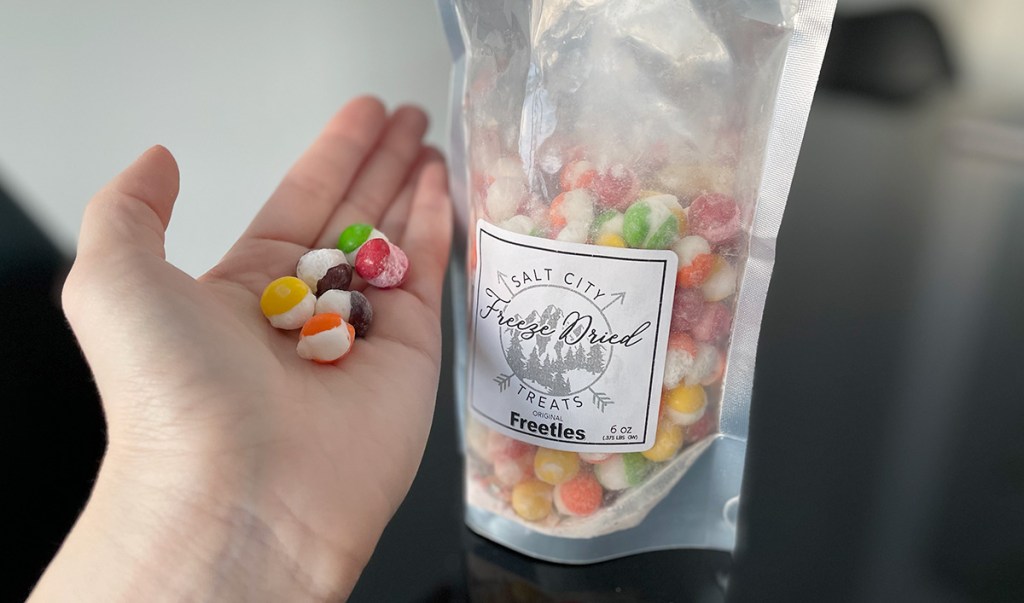 hand holding freeze dried skittles