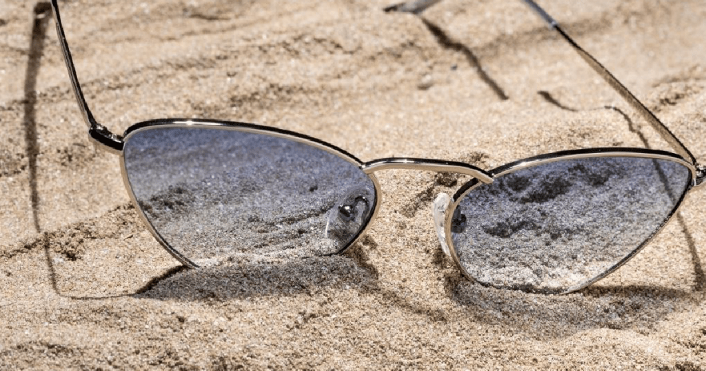 prescription glasses in sand 