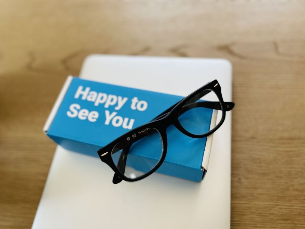 pair of black glasses sitting on a blue box