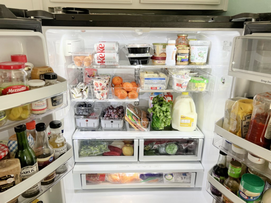 inside of a refrigerator with clear bins