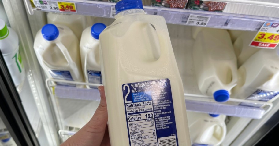 holding a half gallon of milk