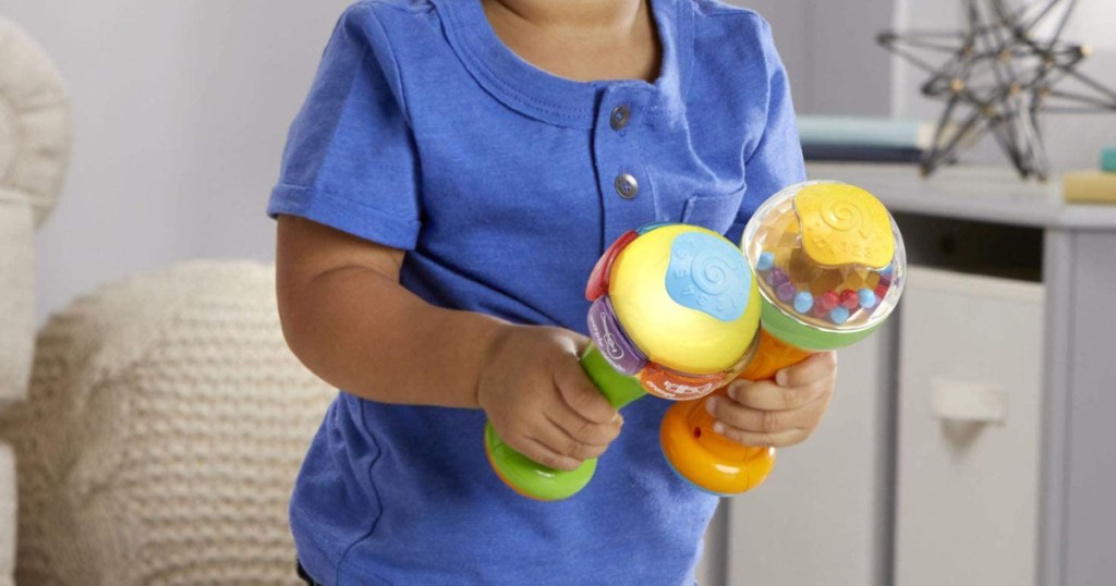 baby holding leapfrog toys