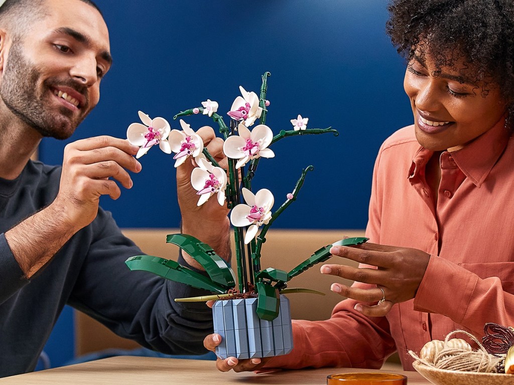 2 adults building a LEGO orchid