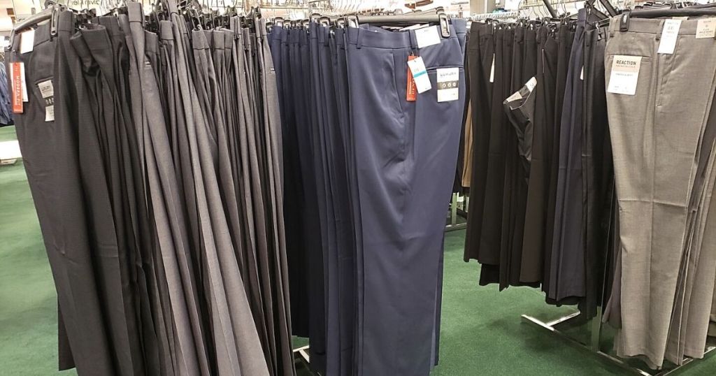 men's suit pants hanging in store
