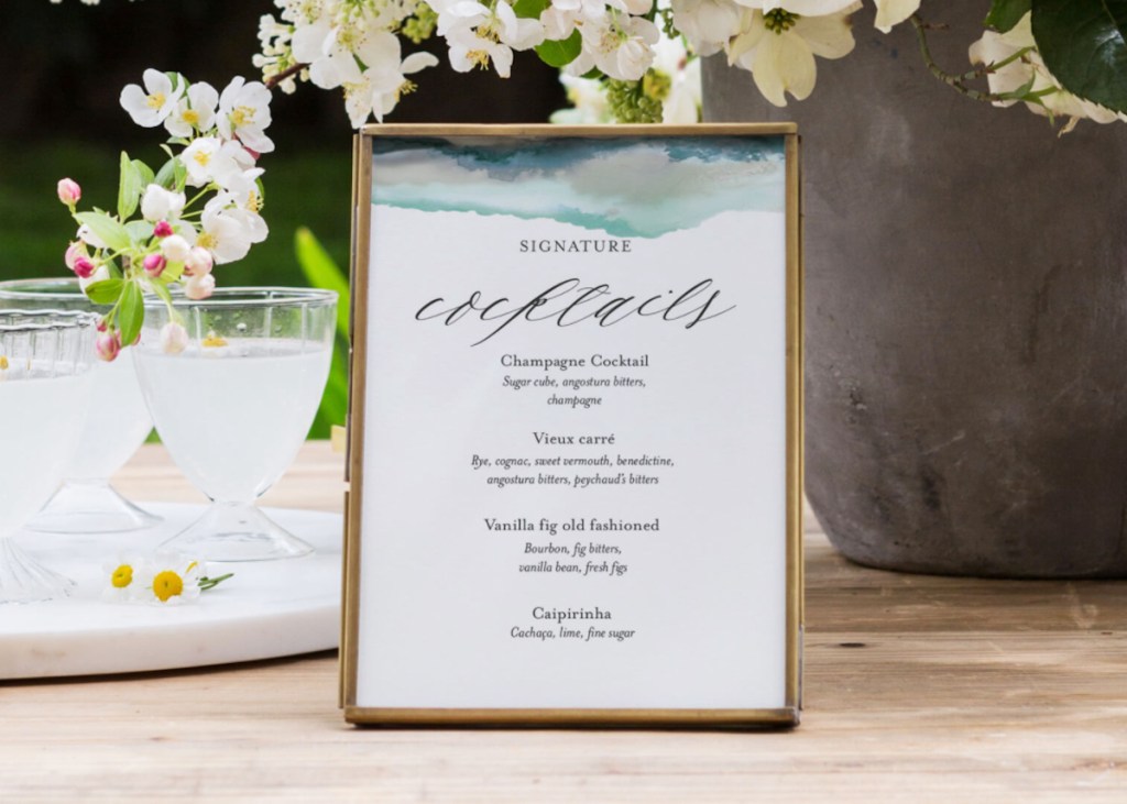 cocktail sign in gold frame sitting on table