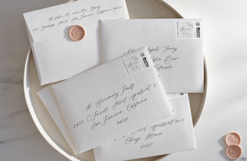 pile of addressed white envelopes with wax seals