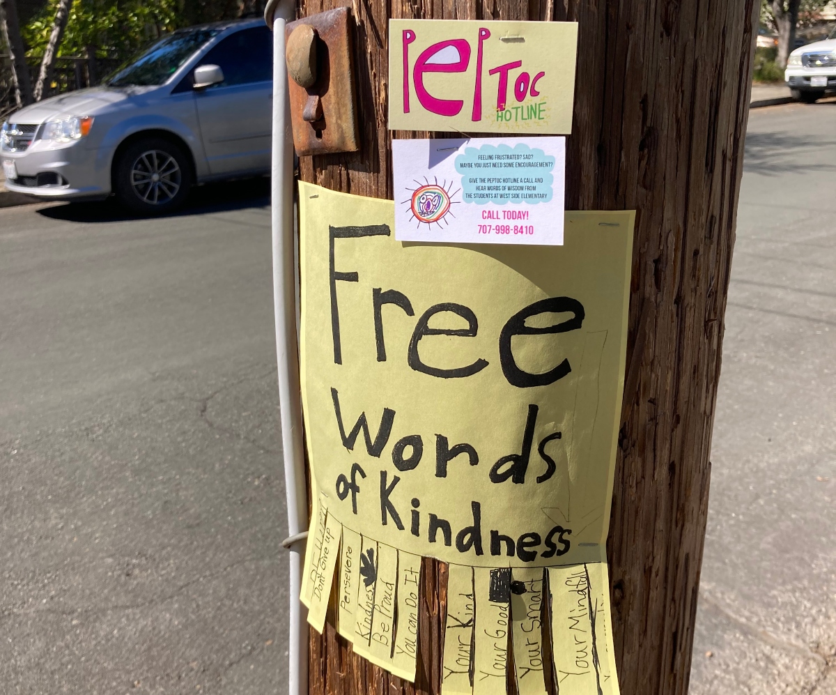free words of encouragement slips and peptoc hotline cards on utility pole