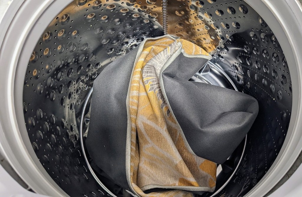inside of stainless steel washing machine with yellow rug inside