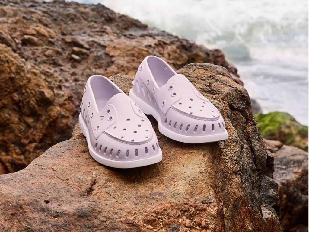 purple Sperry float boat shoes on large rock
