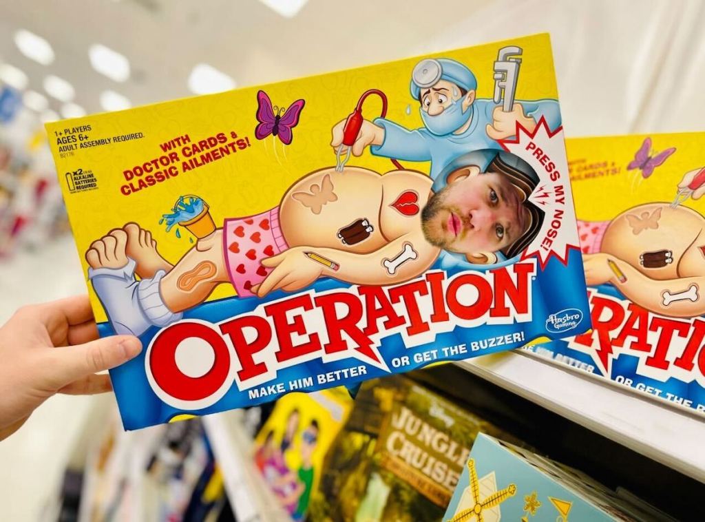 hand holding an operation game from shelf