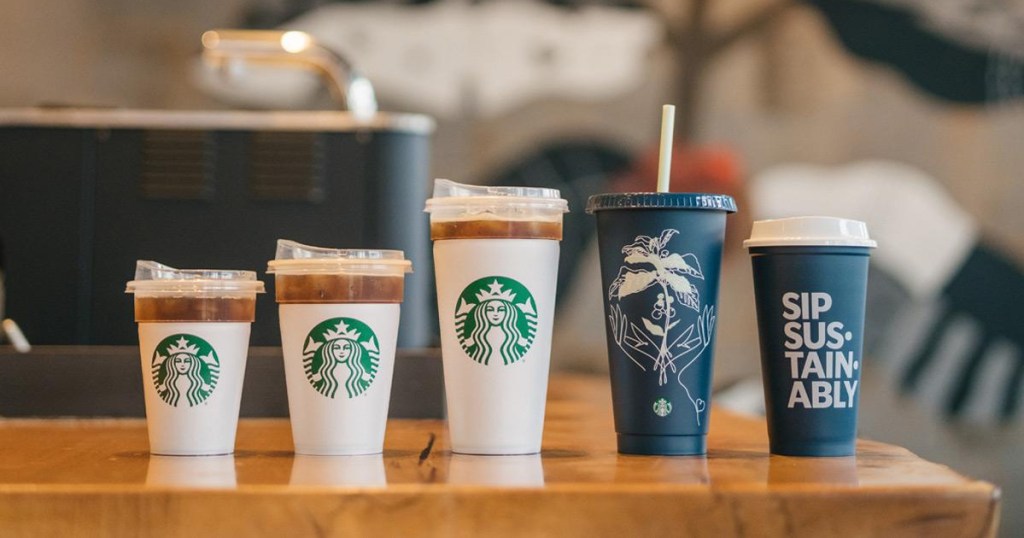 collection of starbucks cups lined up on a countertop