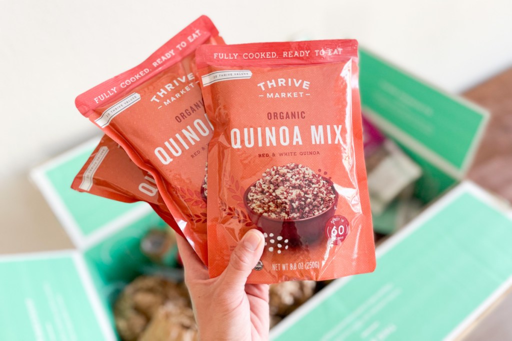hand holding quinoa packs