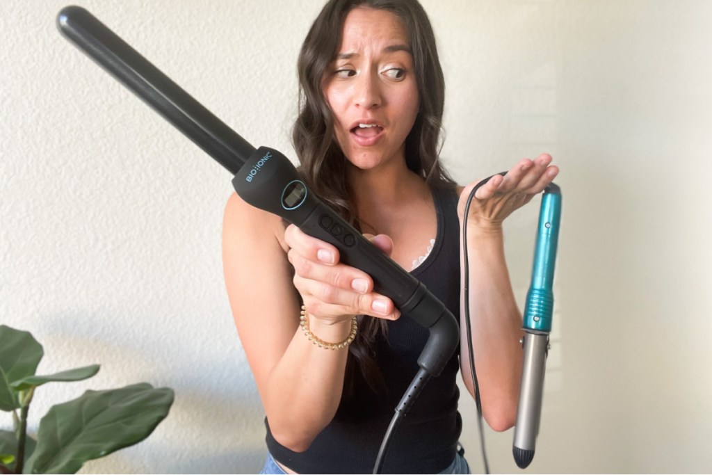 woman making a face at conair curling iron