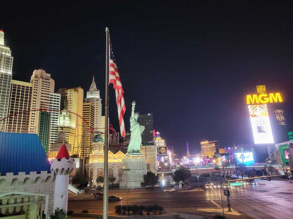 las vegas strip with lights american flag and mgm sign
