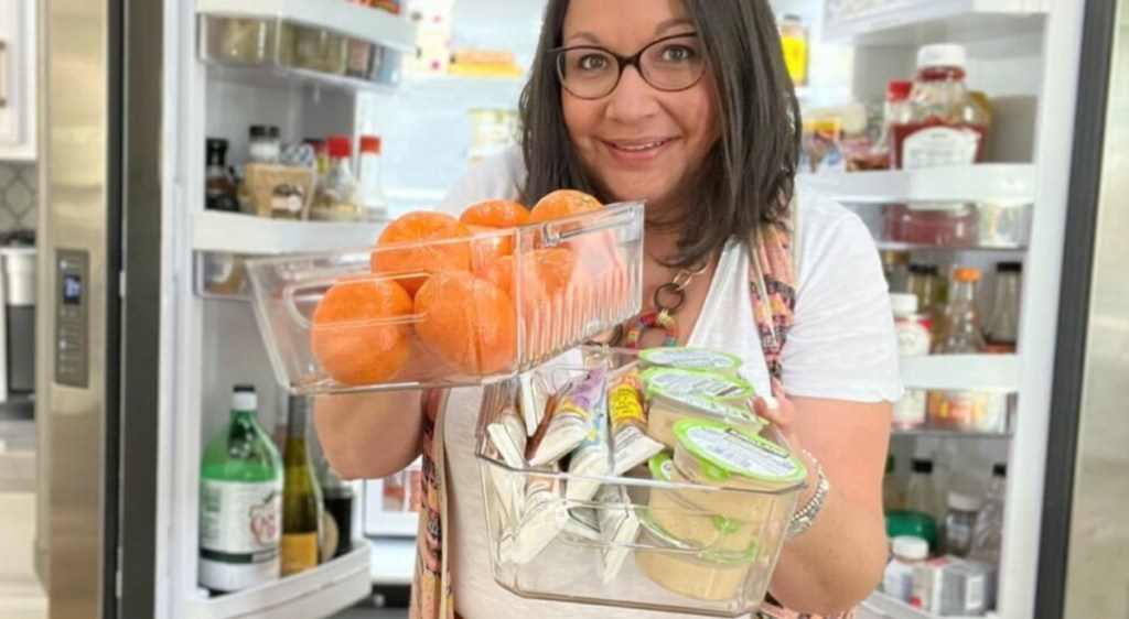 woman holding fridge organization bins