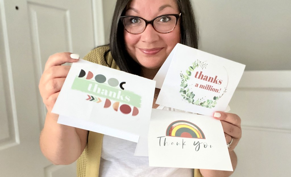 woman holding thank you cards