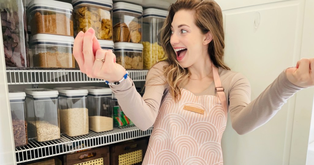 woman snapping to organize pantry