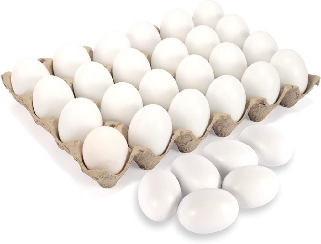 stock image of wooden dyeable easter eggs in and out of a carton