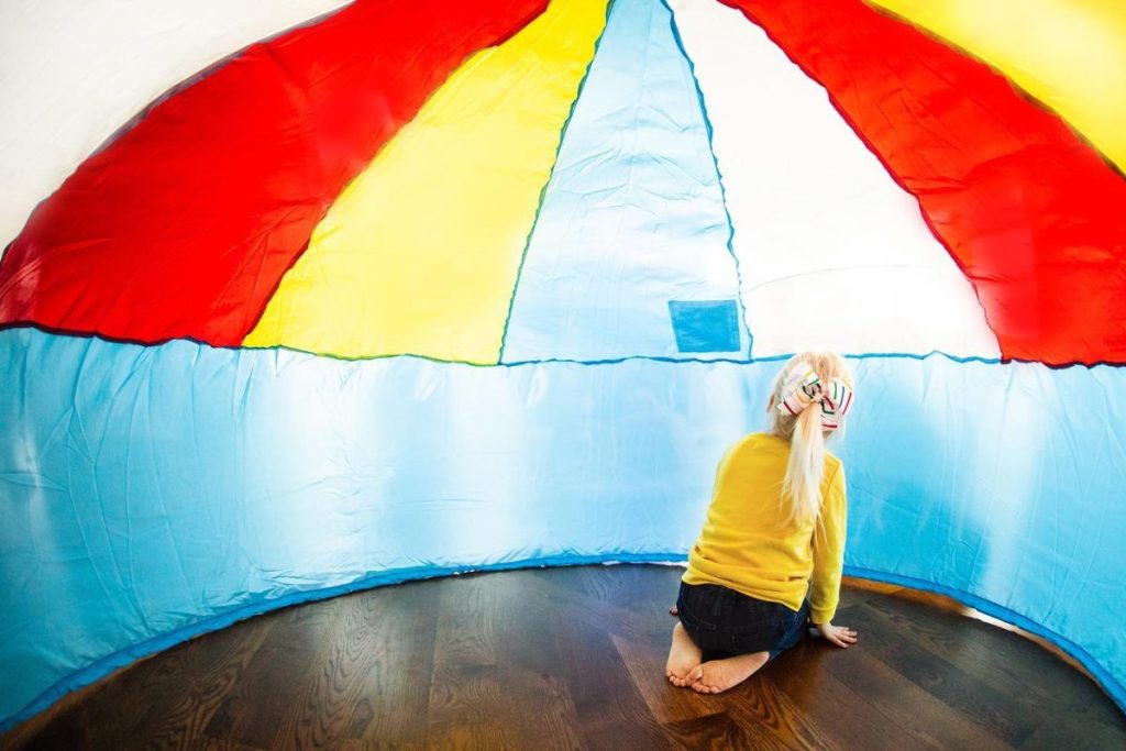 girl in an inflatable fort