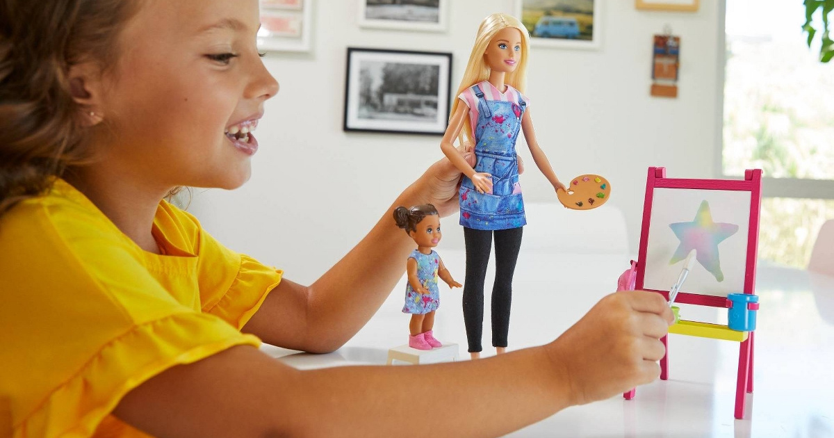 girl playing with art teacher doll playset