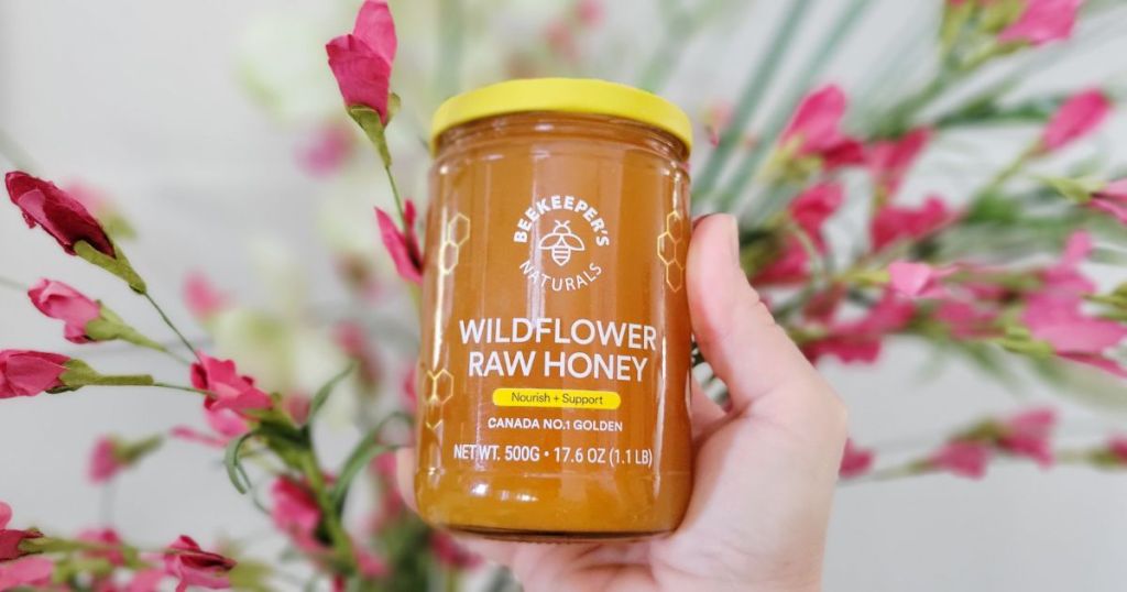 hand holding Beekeeper's Naturals Wildflower Honey