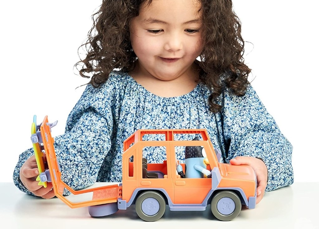 girl playing with a toy truck