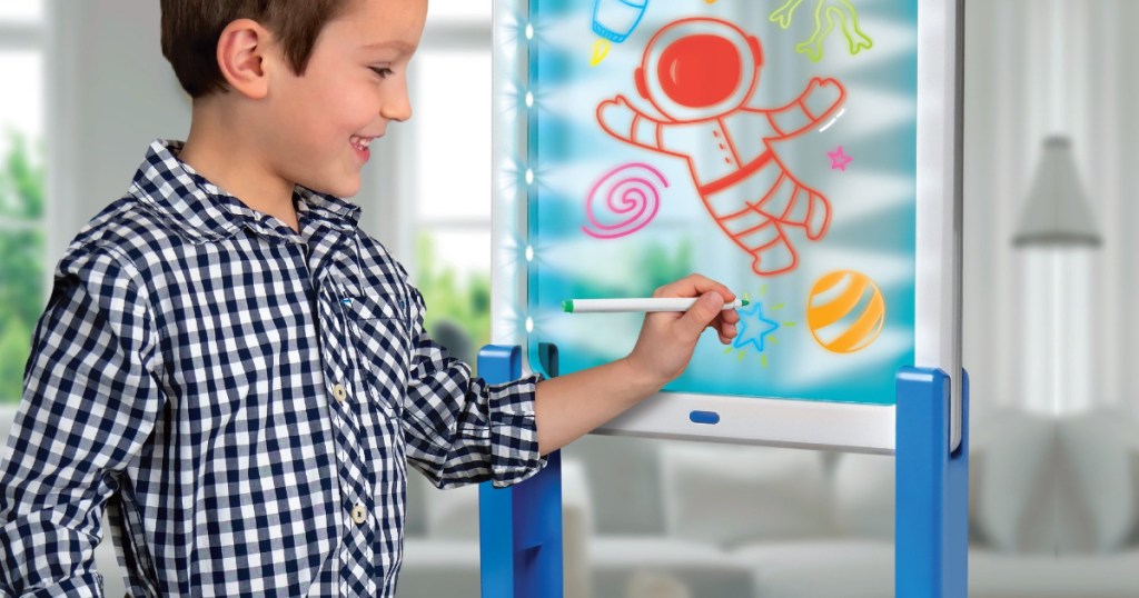 Boy drawing on Discovery light-up easel